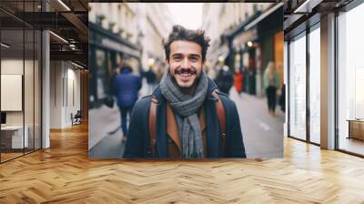 Portrait of a young smiling man standing on the city street in Paris Wall mural