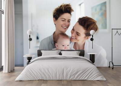 Portrait of happy female Gay couple with baby at home. Concept of lgbt people, lesbian marriage and adoption, homosexual family Wall mural