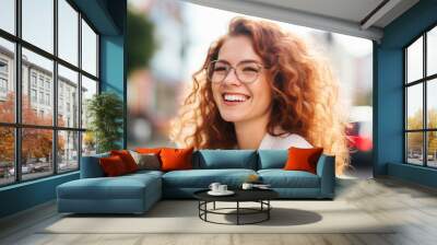 Portrait of happy young woman wearing glasses outdoors	 Wall mural