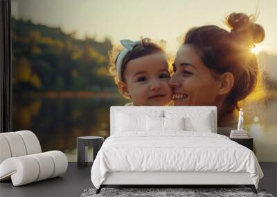 smiling mother holding adorable toddler child outdoors, beautiful nature landscape with lake in the  Wall mural