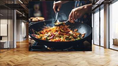 Woman preparing asian food in wok pan at home, close up Wall mural