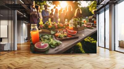 Young and happy people having festive lunch at the beautifully decorated table with healthy food in the garden Wall mural