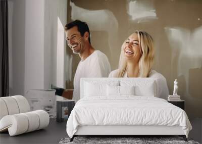 Young married couple painting the walls, happily renovating a newly purchased house Wall mural