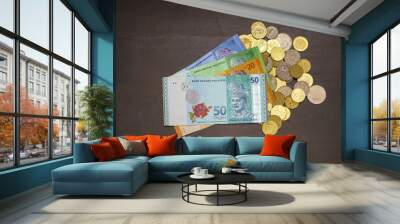 Malaysia Ringgit notes and coins on a wooden background. Wall mural