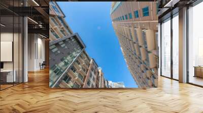 Austin, Texas- Apartment complex buildings in a low angle view. Two buildings across each other with balconies and bricks wall cladding. Wall mural