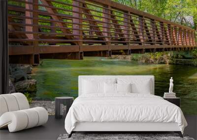 Panorama frame Bridge over glistening river with rocks on the bank at Ogden River Parkway Wall mural