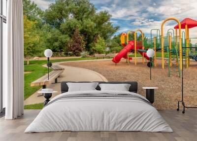 Panorama frame Scenic view at a park with colorful childrens playground and benches on pathway Wall mural