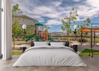 Panorama Park at a sunny neighborhood with childrens playground and pavilion eating area Wall mural