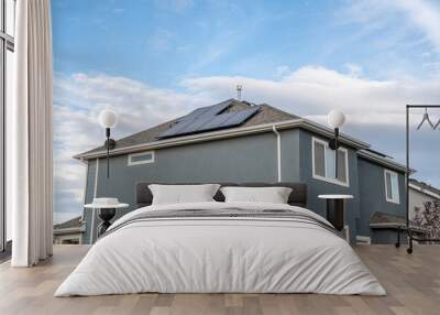 View at the corner of a two storey house with solar panels on the roof Wall mural