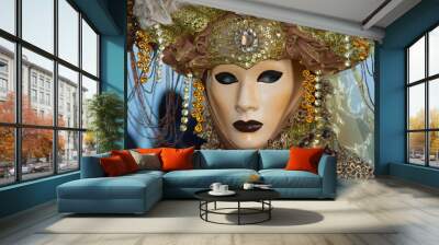 A costumed reveler of the Carnival of Venice in a green and yellow costume looking to the right. Wall mural