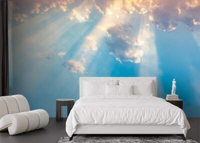 Besutiful ray of sunlight breaking through clouds at sunset. Wall mural