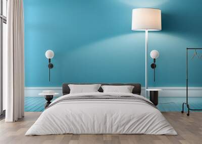 A white lamp is sitting on a wooden floor in front of a blue wall Wall mural