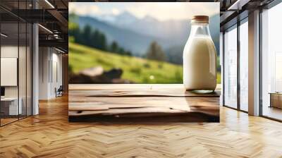 there is a bottle of milk on a table with a mountain in the background Wall mural