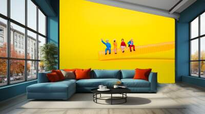 Miniature people, man and woman sitting together on yellow background using as business meeting and social concept Wall mural