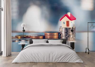 Miniature red house on stack coins using as property real estate and business financial concept Wall mural