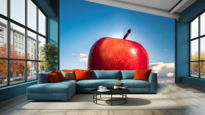 Red apple on blue sky Wall mural