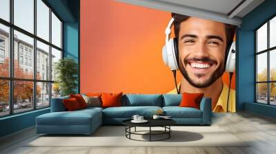 Smiling young man listening to music Wall mural