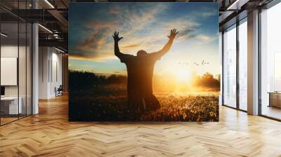 Man raising his hands in worship Wall mural