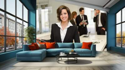 Business leader looking at camera in working environment Wall mural