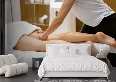 Middle-aged woman having a leg massage in a beauty salon. Wall mural