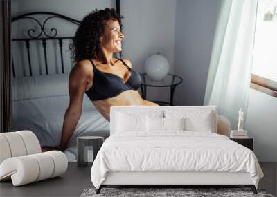 Middle-aged woman In lingerie posing on the bed Wall mural