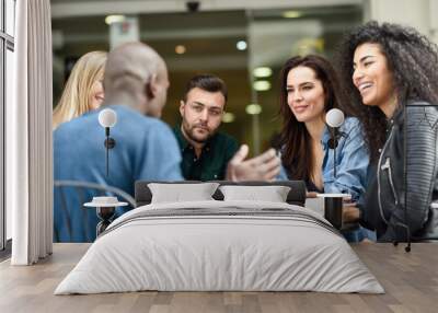 Multiracial group of five friends having a coffee together Wall mural