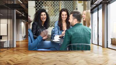 Multiracial group of five friends having a coffee together Wall mural