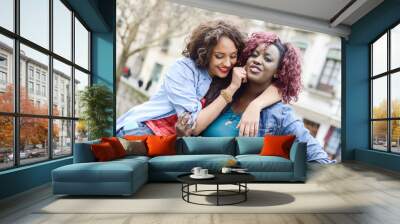 Two beautiful girls in urban backgrund, black and mixed women Wall mural