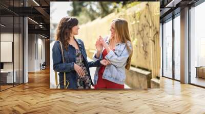 Two young women in urban background. Lifestyle concept. Wall mural