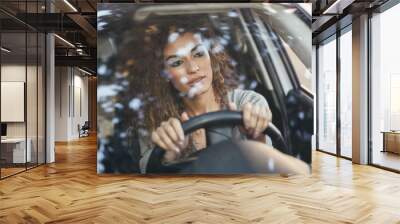 Young arabic woman inside a white car looking through the window Wall mural