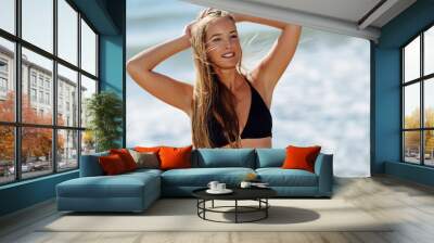 Young blonde woman with beautiful body in swimwear on a tropical beach. Wall mural