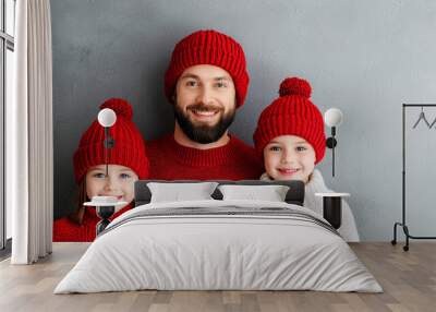 A cheerful family portrait featuring a father and his two daughters Wall mural