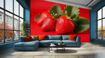 fresh ripe strawberries on red backgrounds with leaves isolated for a vibrant berry showcase Wall mural