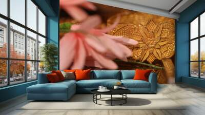 intricately handcrafted broad gold bangle with a pink lily flower near it. Wall mural