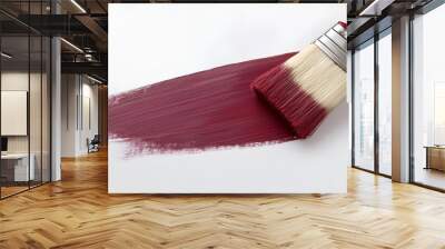 A brush glides across a white surface, applying rich burgundy paint for a creative project in an indoor setting Wall mural