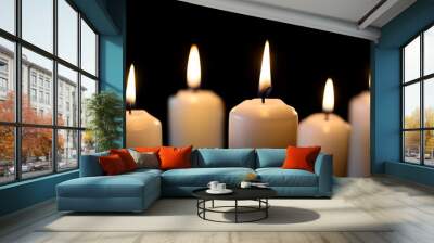 Five White Candles Illuminating Dark Background With Soft Flames Flickering in Evening Atmosphere Wall mural