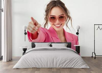 Portrait of happy confident young woman in stylish party outfit. Positive beautiful irish American lady wearing fashionable pink suit and cool sunglasses looking at camera, smiling and pointing at you Wall mural