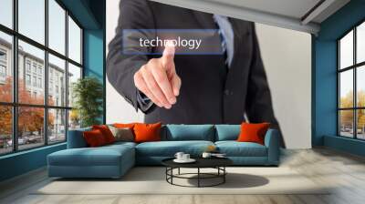 A businessmen is touching a virtual button on screen with technology Wall mural