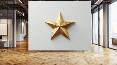 A golden star lying flat on a light surface symbolizing achievement and excellence representing success victory and recognition in a minimalist setting Wall mural