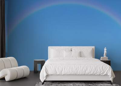 Rainbow on blue sky background with copy space. Wall mural