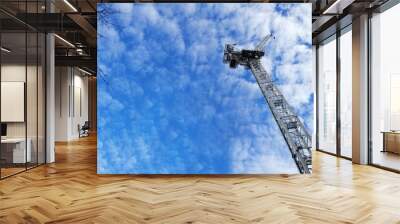 White tower crane with bright blue sky background Wall mural