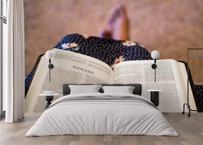 Open bible on female's lap Wall mural