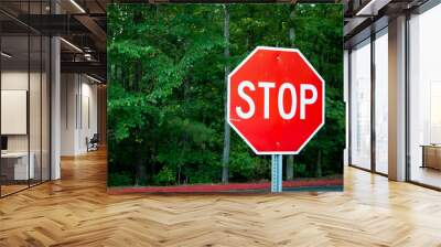 Red stop sign in green area Wall mural