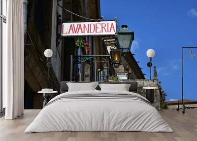 Old laundry sign in old town. Plaza del Obradoiro, Santiago de Compostela, Spain. Wall mural