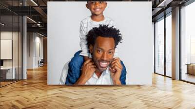 A Young African American Boy Sits Atop the Shoulders of His Dad Wall mural