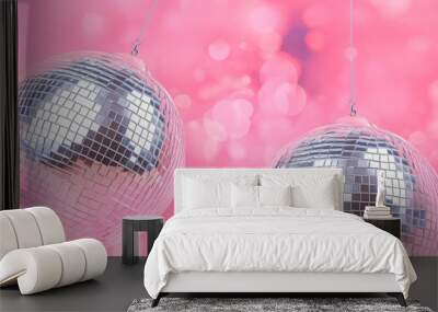 Invitation card with disco balls, pink bokeh background. Concept of nightclub party, christmas celebration, New Year Eve decoration, music entertainment, dancing or nightlife fun. Wall mural