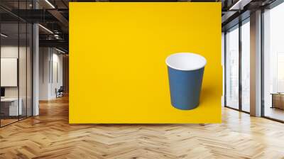 Navy blue paper coffee cup mockup on yellow background, concept of no plastic. Wall mural