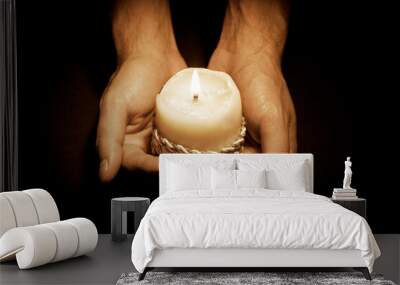 Hands with candle Wall mural