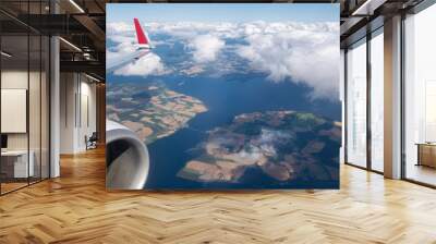 Airplane flying above a fjord Wall mural