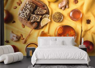 Autumn harvest concept. Set of honey and bee products, apple, lemon, calendula tea, spices on yellow background. Immune system support with alternative medicine Wall mural